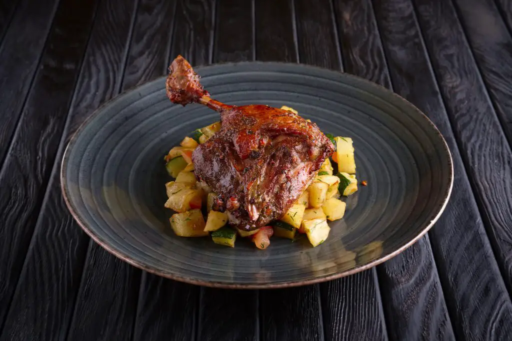 Raising Quail: A Comprehensive Guide To These Remarkable Birds 3 Roasted quail leg with fried potato cubes, zuccini and tomato