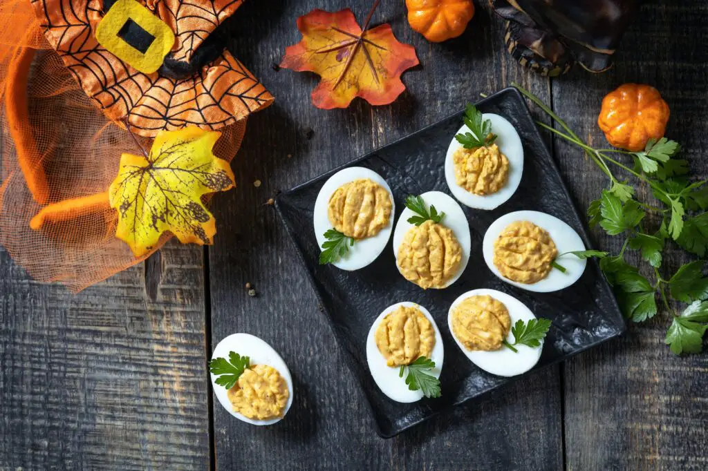 Halloween funny idea for party food. Halloween creative set stuffed eggs pumpkin. Deviled eggs