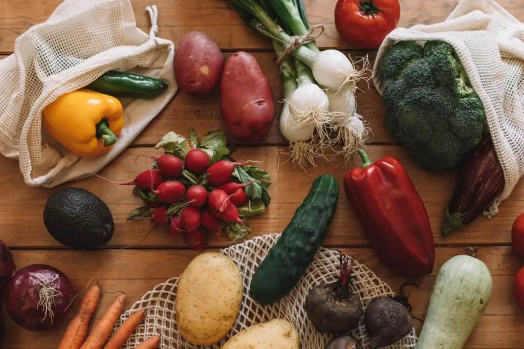 What Is Green Living? A Beginner’s Guide To Making Eco-Friendly Swaps 5 Still life of fresh vegetables with cloth bags on a natural wood base