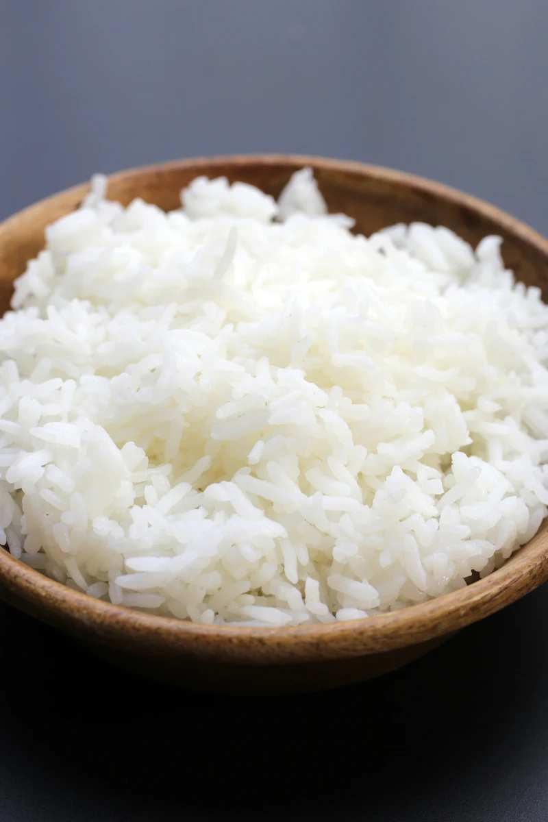 White rice served in a wooden bowl, perfect for a healthy meal or side dish.