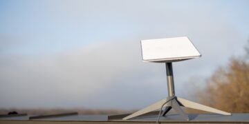 Starlink for homesteads: a starlink satellite dish mounted on the roof of a rural home with a clear view of the sky.